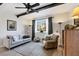 Living room with comfortable seating, accent rugs, dark wood beams, and natural light from the window at 238 Tampa W Ave # 217, Venice, FL 34285