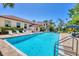 Community pool featuring lounge seating, mature landscaping, and multiple building views at 238 Tampa W Ave # 217, Venice, FL 34285