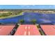 A bird's eye view of the homes' red tile roofs and the lake at 23823 Waverly Cir, Venice, FL 34293