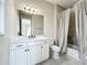Bathroom featuring a vanity with modern fixtures, a large mirror, and a shower/tub combo at 23823 Waverly Cir, Venice, FL 34293