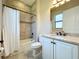 Bathroom with white cabinets, granite countertops, a large mirror, and a shower/tub combo at 23823 Waverly Cir, Venice, FL 34293