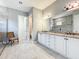 Bright bathroom features double vanity with granite counters, decorative light fixtures, and a large walk-in shower at 23823 Waverly Cir, Venice, FL 34293