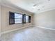 Bedroom featuring tile flooring, black window frames, and a ceiling fan at 23823 Waverly Cir, Venice, FL 34293