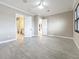 Spacious bedroom with neutral walls, and tile flooring, featuring an open doorway to the ensuite bathroom at 23823 Waverly Cir, Venice, FL 34293