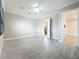 Well-lit bedroom featuring tile flooring, neutral walls, and a ceiling fan at 23823 Waverly Cir, Venice, FL 34293