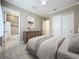 Well-staged bedroom with elegant furniture and decor leading into an ensuite bathroom at 23823 Waverly Cir, Venice, FL 34293