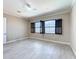 Bright bedroom with a view, featuring tile flooring, black window frames, and a ceiling fan at 23823 Waverly Cir, Venice, FL 34293