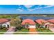 Well-manicured landscaping enhances the curb appeal of this home near the lake at 23823 Waverly Cir, Venice, FL 34293