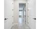 Bright hallway featuring tile floors and white doors at 23823 Waverly Cir, Venice, FL 34293