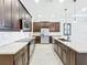Modern kitchen design with dark wood cabinets, stainless steel appliances, and a large central island at 23823 Waverly Cir, Venice, FL 34293