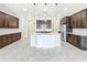 Large kitchen with dark cabinets, white countertops, mosaic backsplash, and tile floors at 23823 Waverly Cir, Venice, FL 34293