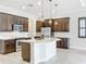 Kitchen with dark cabinets, white countertops, island, and tile floors at 23823 Waverly Cir, Venice, FL 34293