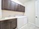 Laundry room features sink, wood cabinets, and washer and dryer at 23823 Waverly Cir, Venice, FL 34293