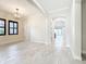 Bright living room with neutral paint, black framed windows, archways, and tile floors at 23823 Waverly Cir, Venice, FL 34293