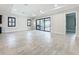 Bright open-plan living area with tile flooring, shutters, and seamless access to the outdoors through sliding glass doors at 23823 Waverly Cir, Venice, FL 34293