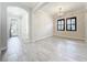 Living room featuring tile floors, shuttered windows and an arched entryway at 23823 Waverly Cir, Venice, FL 34293