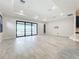 Open living space with tile floors and large sliding doors leading to outdoor views, filling room with light at 23823 Waverly Cir, Venice, FL 34293