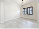 Bright living room with neutral paint, black framed windows, and tile floors at 23823 Waverly Cir, Venice, FL 34293
