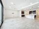 Expansive living area flows to the kitchen, featuring tile flooring and abundant natural light at 23823 Waverly Cir, Venice, FL 34293