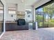 Covered patio includes an outdoor kitchen with brick pavers and stainless-steel appliances at 23823 Waverly Cir, Venice, FL 34293