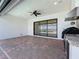 Covered patio includes an outdoor kitchen with brick pavers and a ceiling fan at 23823 Waverly Cir, Venice, FL 34293