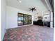 Covered patio includes an outdoor kitchen with brick pavers and a view of the lake at 23823 Waverly Cir, Venice, FL 34293