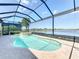 This screened pool and spa offer a relaxing view of the lake and surrounding greenery at 23823 Waverly Cir, Venice, FL 34293