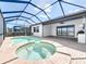 Relaxing screened pool and spa area with a patio and outdoor kitchen offer a luxurious backyard experience at 23823 Waverly Cir, Venice, FL 34293