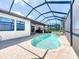 The screened pool and outdoor kitchen make for the perfect outdoor living space at 23823 Waverly Cir, Venice, FL 34293