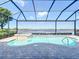 A sparkling pool and spa are enclosed within a screened lanai, offering a tranquil view of the lake beyond at 23823 Waverly Cir, Venice, FL 34293