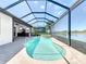 Screened pool and kitchen area overlooking the lake provides an outdoor living experience at 23823 Waverly Cir, Venice, FL 34293