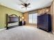 Spacious bedroom with a dark wood dresser and a bed frame awaiting completion at 23901 Waverly Cir, Venice, FL 34293