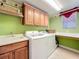 Convenient laundry room with washer, dryer, and ample counter space at 23901 Waverly Cir, Venice, FL 34293