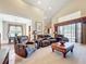 A large and well-lit living room, featuring multiple seating areas at 23901 Waverly Cir, Venice, FL 34293