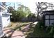 Spacious backyard featuring a brick path, mature trees, and wooden fence for privacy at 332 E Langsner St, Englewood, FL 34223