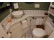 Green bathroom featuring black and white floor tiles and vessel sink at 332 E Langsner St, Englewood, FL 34223