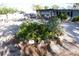 Landscaped front yard with a circular flower bed and gravel covering the ground at 332 E Langsner St, Englewood, FL 34223