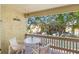 Relaxing balcony with seating and a lovely view of the well-maintained community grounds at 3417 Clark Rd # 217, Sarasota, FL 34231