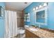 The bathroom is vibrant with stylish fixtures, granite countertops, and mosaic tile accents at 3417 Clark Rd # 217, Sarasota, FL 34231