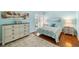 Comfortable bedroom with light-blue walls, wood floors, and lots of natural light at 3417 Clark Rd # 217, Sarasota, FL 34231