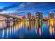Stunning waterfront view of the city skyline, illuminated bridge, and vibrant reflections on the water at 3417 Clark Rd # 217, Sarasota, FL 34231