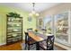 Bright dining area with large windows, a dining table, and stylish shelving at 3417 Clark Rd # 217, Sarasota, FL 34231