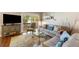 Comfortable living room with a large television, access to a deck, and inviting decor at 3417 Clark Rd # 217, Sarasota, FL 34231