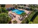 A refreshing community pool is surrounded by a brick patio, palm trees, and lounge chairs at 3417 Clark Rd # 217, Sarasota, FL 34231