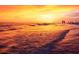 A stunning sunset over the ocean, casting a warm golden glow on the water and beach at 3417 Clark Rd # 217, Sarasota, FL 34231