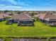 Aerial view of screened-in pool, backyard and lake perfect for relaxation and entertaining at 3459 Lakewood Blvd, North Port, FL 34287