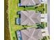 This aerial shot shows meticulously landscaped lawns, a private pool, and pristine driveways at 3459 Lakewood Blvd, North Port, FL 34287