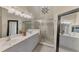 The bathroom features a double vanity, shower, and ample lighting for a luxurious experience at 3459 Lakewood Blvd, North Port, FL 34287