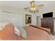 Relaxing bedroom featuring a ceiling fan, a dresser, and comfortable bedding at 3459 Lakewood Blvd, North Port, FL 34287