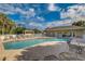 Inviting community pool area featuring comfortable lounge chairs, tables, and a shaded gazebo at 3459 Lakewood Blvd, North Port, FL 34287
